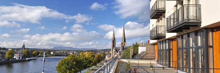 An exterior view of the Highland Apartments and terrace overlooking the River Ness