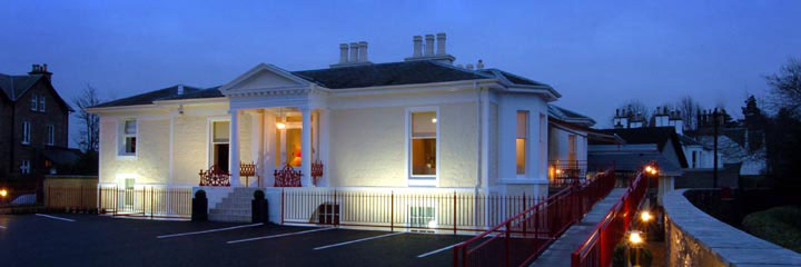 The exterior of the 5 star Rocpool Reserve Hotel in Inverness, lit up at night