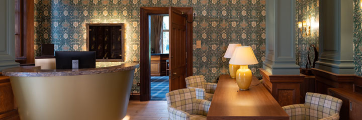 The welcoming reception area of the Schloss Roxburghe Hotels which combines modern and traditional, in keeping with the heritage of the building, including some original features.