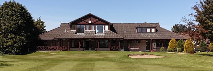 The 18th green and clubhouse at Alford Golf Club, and easy walking parkland golf course in Aberdeenshire