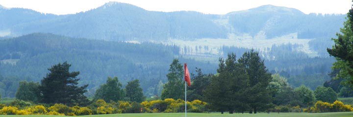 A view across Royal Deeside to the mountains from the 18th green of the heathland Ballater golf course