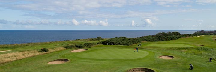 A view over Buckpool Golf Club looking to the Moray Firth and showing the traditional links style pot bunkers around a green