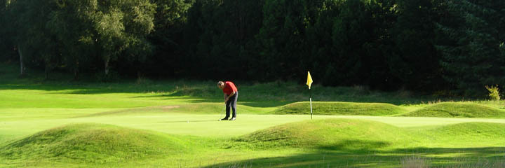 Putting out on the 9th green at Cochrane Castle Golf Club