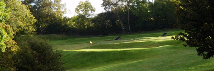 The green at the 1st hole of Cochrane Castle golf course
