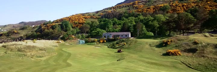 Looking towards the 8th green at Gairloch Golf Club on the west coast of Scotland with gorse covered hills behind the course