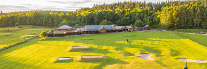 The driving range and clubhouse at Inchmarlo Golf Resort in Aberdeenshire