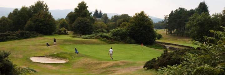 A view of one of the greens at Kilmacolm Golf Club showing the mature woodland around the course