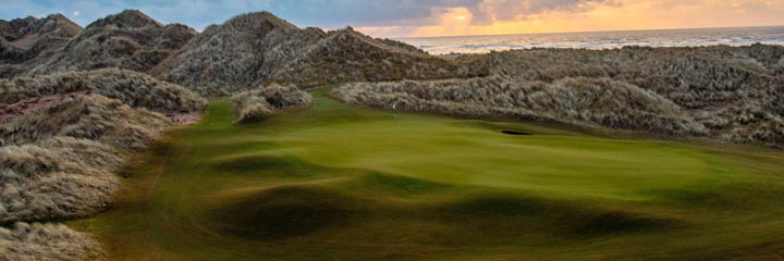 The 14th green at Trump International Golf Links, Scotland showing the height of the extensive dunes which surround the course