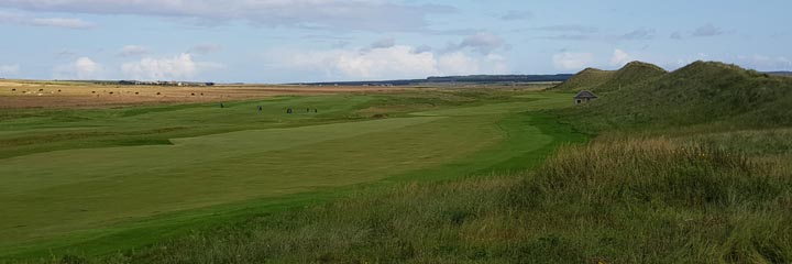 The links of Wick Golf Club in the North of Scotland, with the towering grassy sand dunes to the right that separate the course from the sea